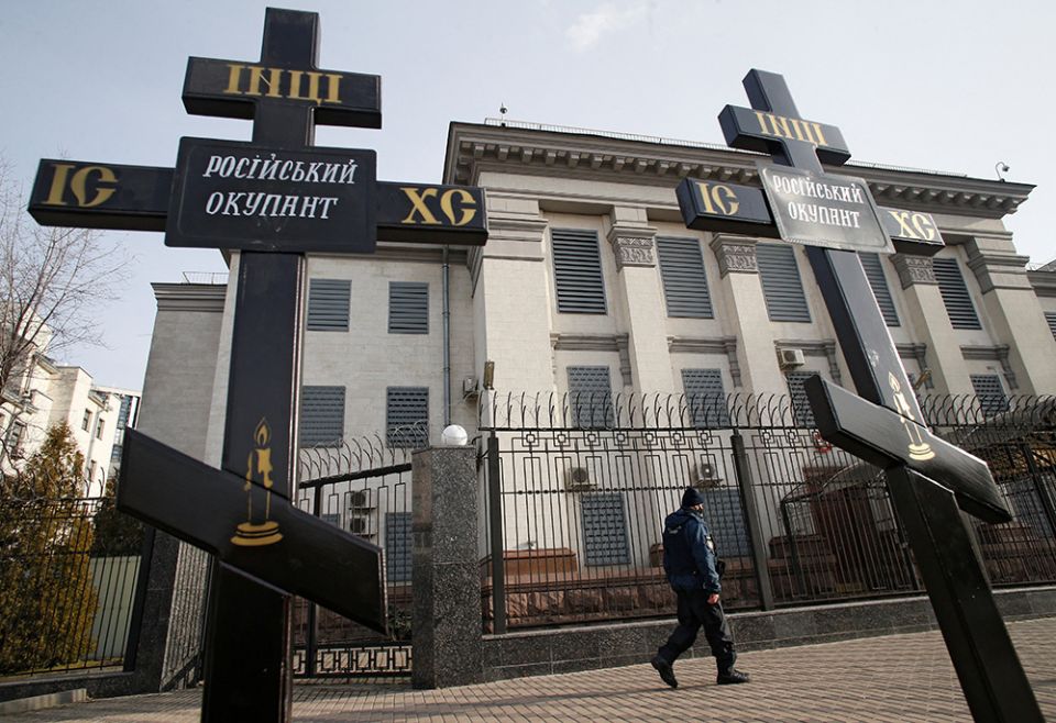 Crosses installed during a protest against Russia's actions in eastern Ukraine are pictured Feb. 23 in front of the Russian Embassy in Kyiv, Ukraine. The signs on the crosses read: "Russian occupier." (CNS/Reuters/Valentyn Ogirenko) Crosses installed during a protest against Russia's actions in eastern Ukraine are pictured Feb. 23 in front of the Russian Embassy in Kyiv, Ukraine. The signs on the crosses read: "Russian occupier." (CNS/Reuters/Valentyn Ogirenko)