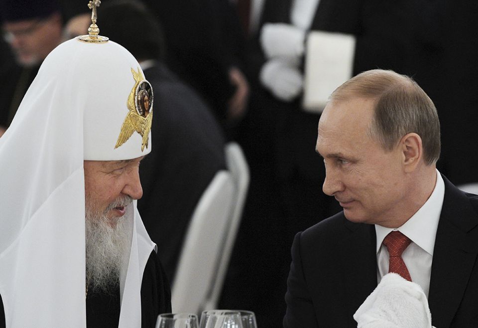 Russian President Vladimir Putin, right, listens to Russian Orthodox Patriarch Kirill of Moscow during a reception at the Kremlin in Moscow in this July 28, 2015, file photo. (CNS)