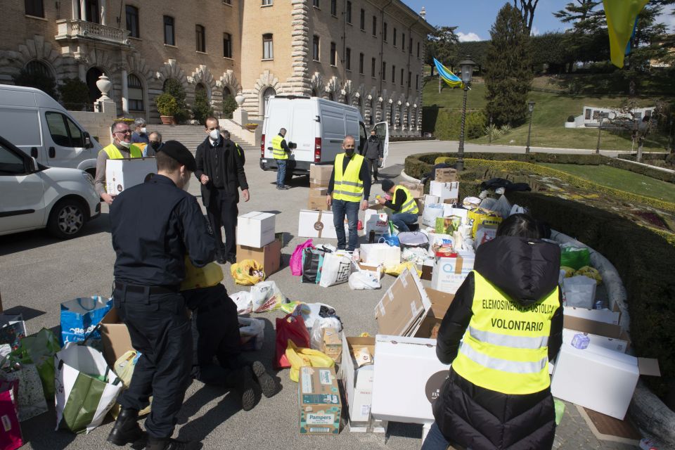 People sort donations from Vatican employees for Ukraine outside the Governatorato, a building housing the Vatican's governing offices, at the Vatican March 7, 2022. (CNS photo/Vatican Media)