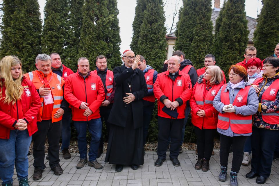 Canadian Cardinal Michael Czerny, interim president of the Dicastery for Promoting Integral Human Development, is pictured with Caritas workers as he gives a blessing during a visit with Ukrainian refugees in Barabás, Hungary, March 9, 2022. (CNS photo/co