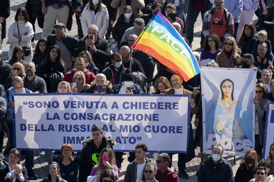 People in St. Peter's Square hold an image of Mary and peace flags during Pope Francis' recitation of the Angelus at the Vatican March 13, 2022. (CNS photo/Vatican Media)