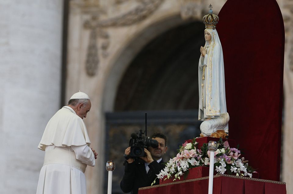 Pope Francis prays in front of the original statue of Our Lady of Fatima during a Marian vigil in St. Peter's Square at the Vatican on Oct. 12, 2013.