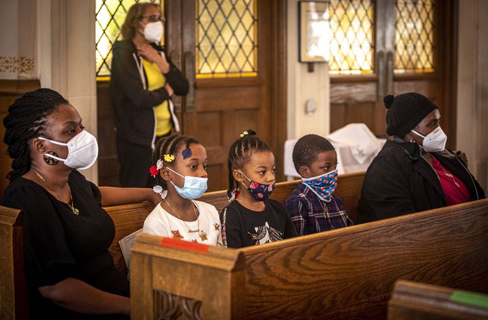 A family attends Mass at St. Barbara Catholic Church in Philadelphia Feb. 6. (CNS/Chaz Muth)