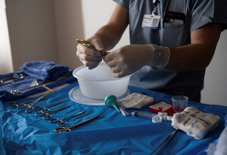 A doctor at Beaumont Hospital in Royal Oak, Michigan, prepares medical supplies Feb. 1. (CNS/Reuters/Emily Elconin)
