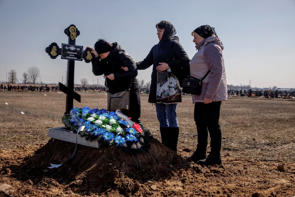 Family members of Borys Romanchenko attend his funeral in Kharkiv, Ukraine, March 24, 2022. Romanchenko, a 96-year-old Holocaust survivor, was killed at his apartment during shelling by Russian forces. (CNS photo/Thomas Peter, Reuters)