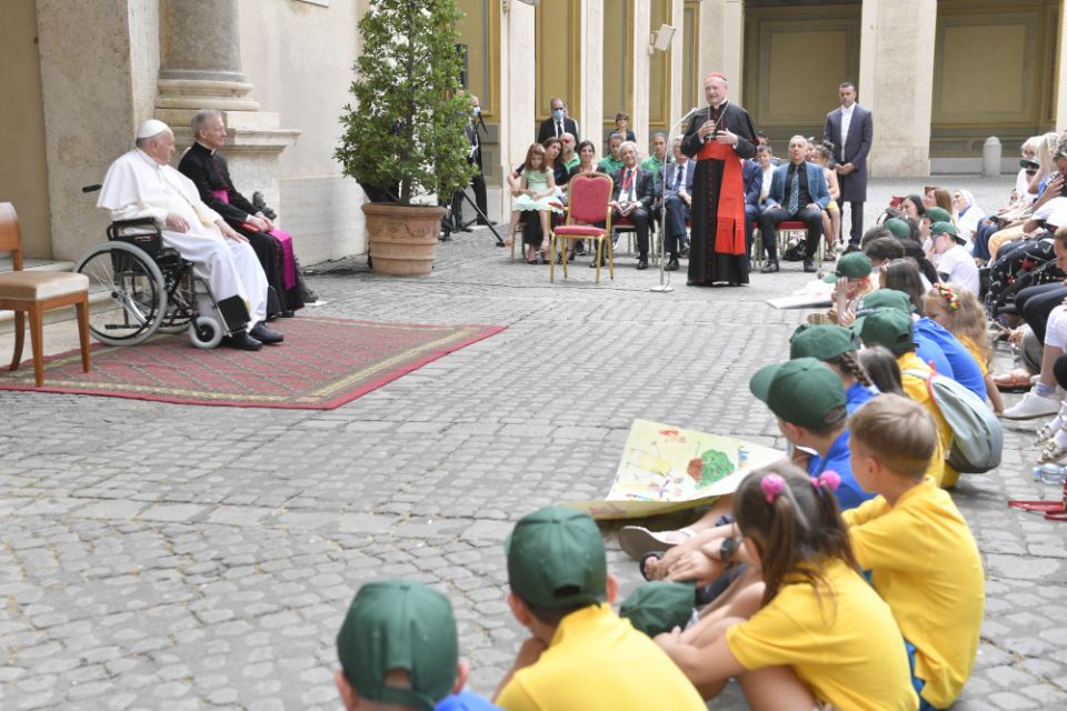 Pope Francis listens as Cardinal Gianfranco Ravasi, president of the Pontifical Council for Culture, speaks during an audience with some 160 children in the San Damaso Courtyard at the Vatican June 4. (CNS/Vatican Media)
