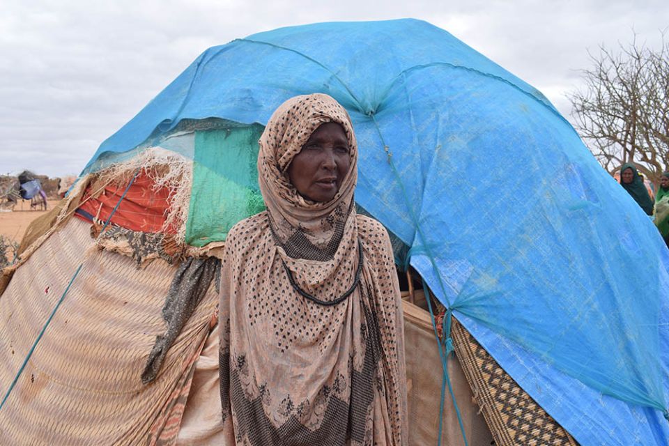 A woman forced to flee her home because of drought is pictured outside her tent in Qurdubay camp near Dolow, Somalia, April 13. (CNS/Trócaire/Miriam Donohoe)