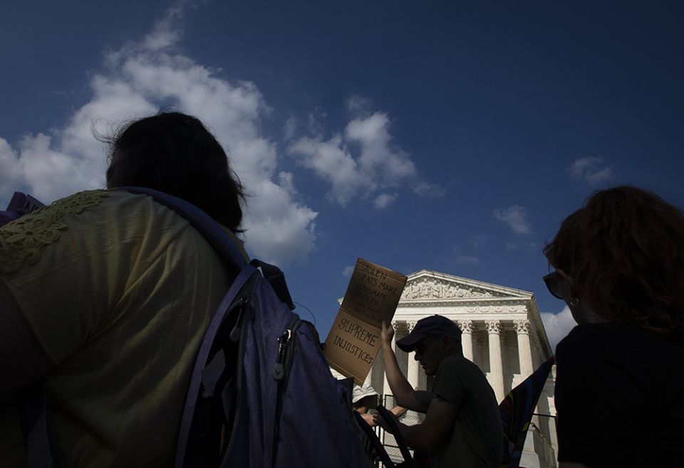 Abortion demonstrators are seen near the Supreme Court June 24 in Washington, as the court overruled the landmark Roe v. Wade abortion decision in its ruling in the Dobbs case on a Mississippi law banning most abortions after 15 weeks. (CNS/Tyler Orsburn) Abortion demonstrators are seen near the Supreme Court June 24 in Washington, as the court overruled the landmark Roe v. Wade abortion decision in its ruling in the Dobbs case on a Mississippi law banning most abortions after 15 weeks. (CNS/Tyler Orsburn)
