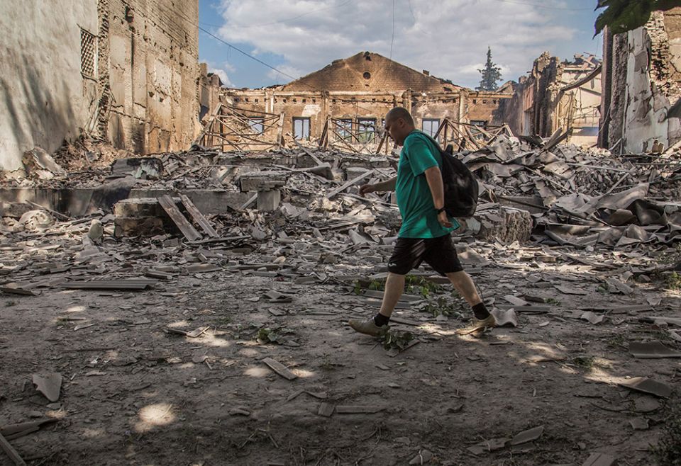 A local resident walks in a front of a building destroyed by a Russian military airstrike in a photo taken June 17 in Lysychansk, Ukraine. (CNS/Reuters/Oleksandr Ratushniak) A local resident walks in a front of a building destroyed by a Russian military airstrike in a photo taken June 17 in Lysychansk, Ukraine. (CNS/Reuters/Oleksandr Ratushniak)