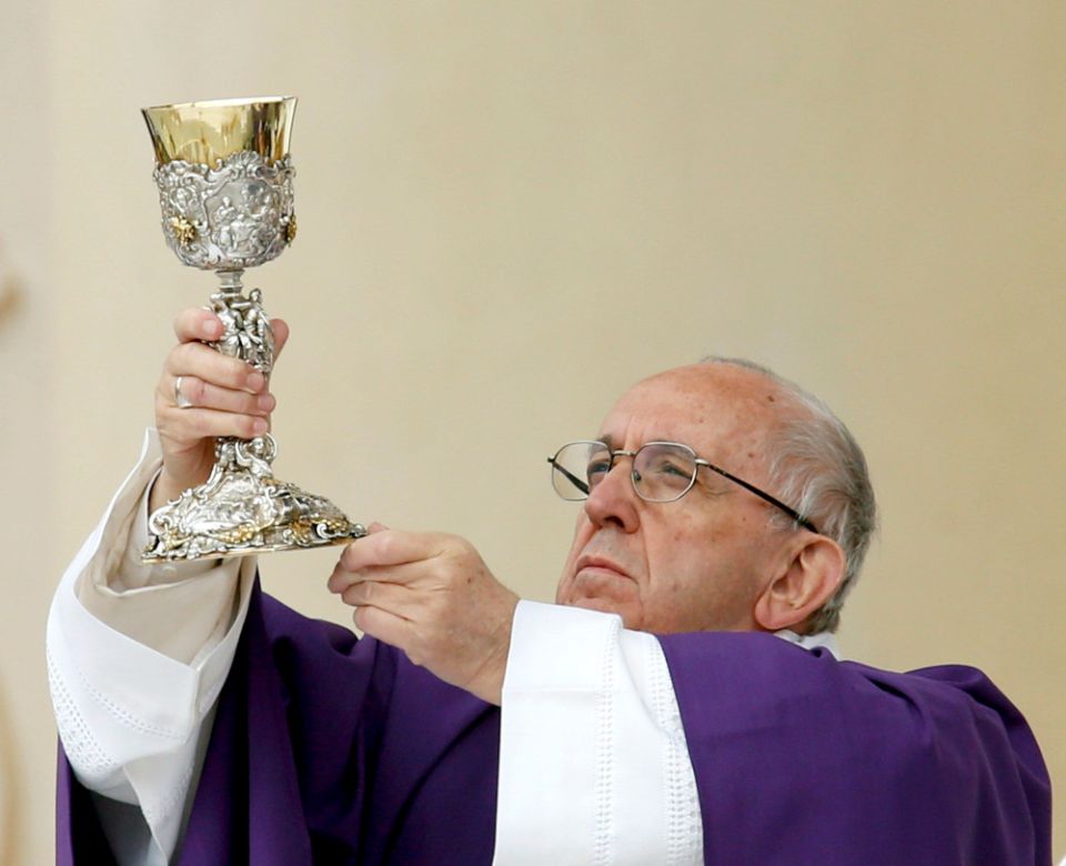 Pope Francis elevates the chalice as he celebrates Mass in Carpi, Italy, April 2, 2017. (CNS/Reuters/Alessandro Garofalo)