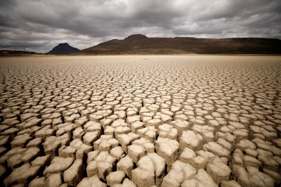 Clouds gather but produce no rain as cracks are seen in the dried-up municipal dam in drought-stricken Graaff-Reinet, South Africa, Nov.14, 2019. (CNS/Reuters/Mike Hutchings)