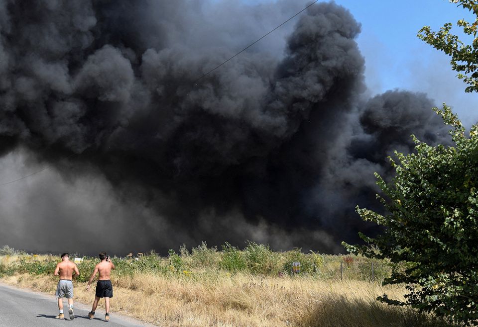 People watch as a fire burns during a heatwave July 19 in London. London's fire service had its busiest day since World War II dealing with several blazes in record-breaking temperatures, London Mayor Sadiq Khan said. (CNS/Reuters/Tony O'Brien) People watch as a fire burns during a heatwave July 19 in London. London's fire service had its busiest day since World War II dealing with several blazes in record-breaking temperatures, London Mayor Sadiq Khan said. (CNS/Reuters/Tony O'Brien)