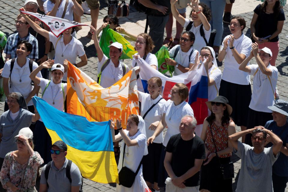 Nuns hold a Ukrainian flag as Pope Francis leads the Angelus from the window of his studio overlooking St. Peter's Square at the Vatican July 31, 2022. (CNS photo/Vatican Media via Reuters)