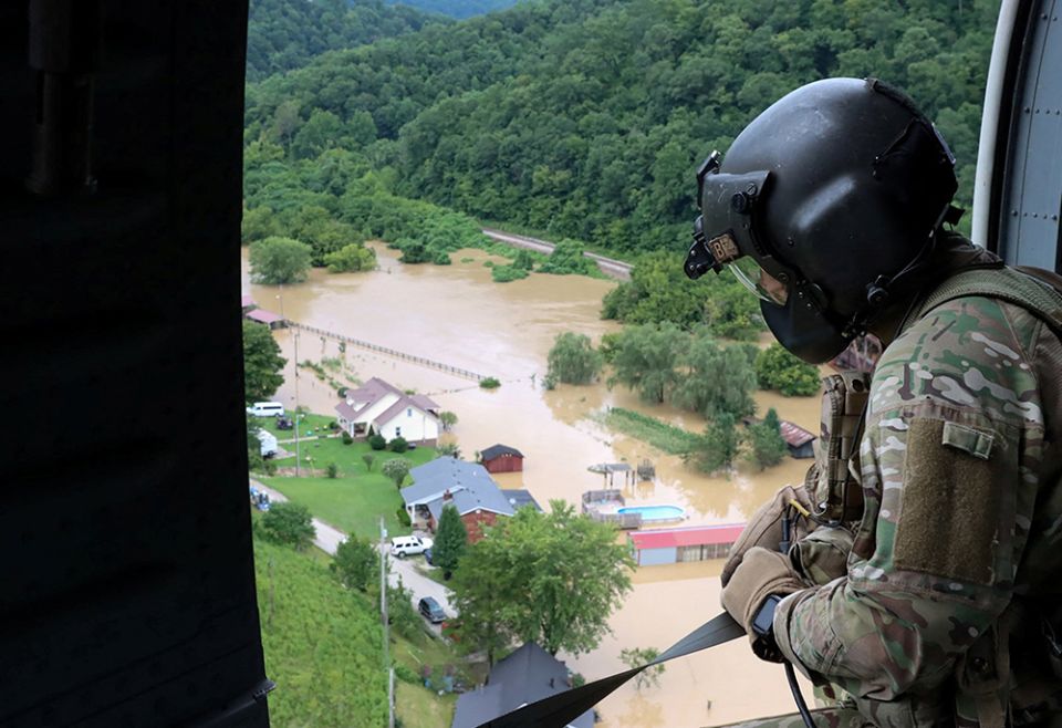A Kentucky National Guard flight crew from 2/147th Bravo Company flies over a flooded area in response to a declared state of emergency July 29 in eastern Kentucky. (CNS/Sgt. Jesse Elbouab, U.S. Army National Guard via Reuters)