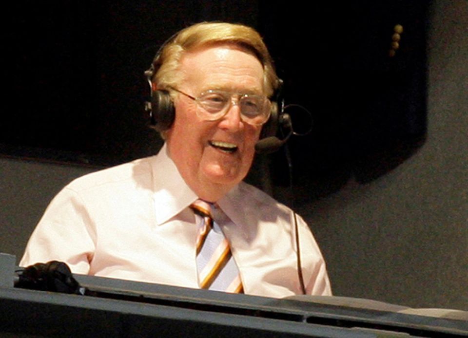 Legendary Los Angeles Dodgers announcer Vin Scully smiles in a broadcast booth during the National League MLB baseball game between the San Francisco Giants and the Los Angeles Dodgers in Los Angeles, April 25, 2007