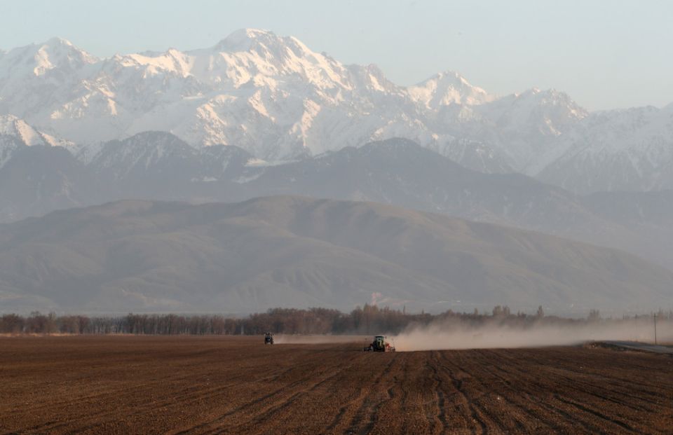 Agricultural workers operate tractors in a field in the Almaty region of Kazakhstan April 6. Pope Francis is scheduled to visit Kazakhstan Sept.  13-15 to attend the Congress of World and Traditional Religions.  (CNS photo/Reuters/Pavel Mikheyev)
