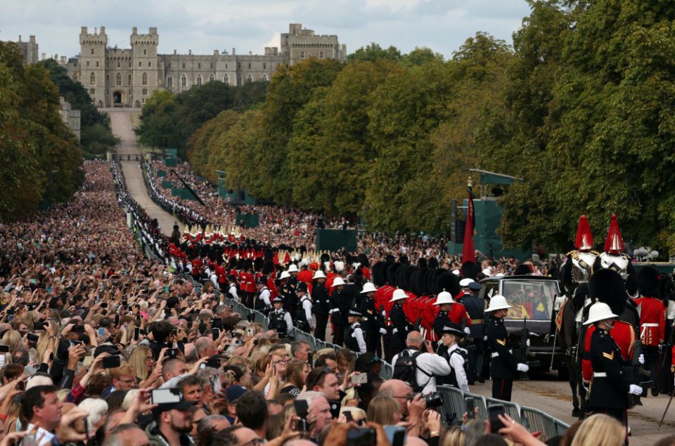 The hearse carrying the casket of Britain's Queen Elizabeth II is escorted along the Long Walk toward Windsor Castle toward her burial Sept. 19, 2022. (CNS photo/Paul Childs, Reuters)