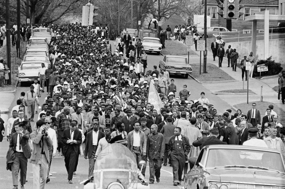FILE – In this March 17, 1965, file photo, demonstrators walk to the courthouse behind the Rev. Martin Luther King Jr. in Montgomery, Ala. The march was to protest treatment of demonstrators by police during an attempted march. (AP Photo/File)
