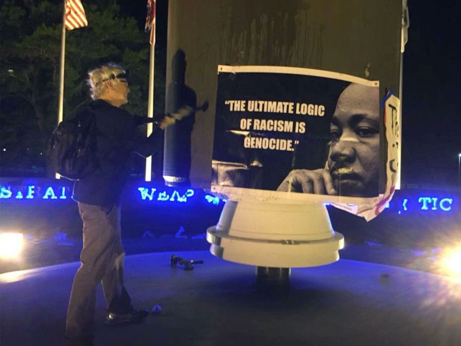 Patrick O'Neill hammers a monument to nuclear war at Kings Bay Naval Submarine Base in April 2018. He was sentenced to 14 months in federal prison after being convicted on several charges.