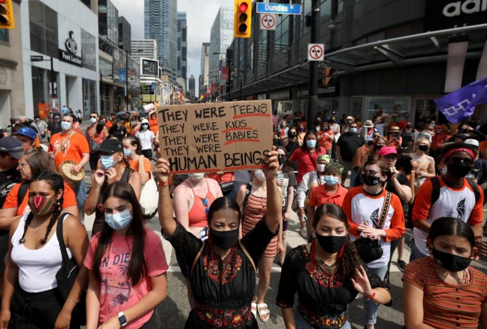 People march on Canada Day in Toronto July 1, 2021, after the discovery of hundreds of unmarked graves on the grounds of two former residential schools for Indigenous children in Canada. (CNS/Reuters/Carlos Osorio)