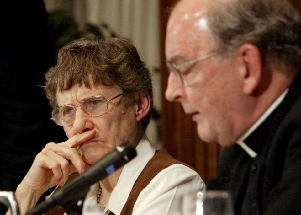 Theologian Monika Hellwig, president and executive director of the Association of Catholic Colleges and Universities, listens to remarks from Richard John Neuhaus, editor of the journal First Things, during a conference in 2004.