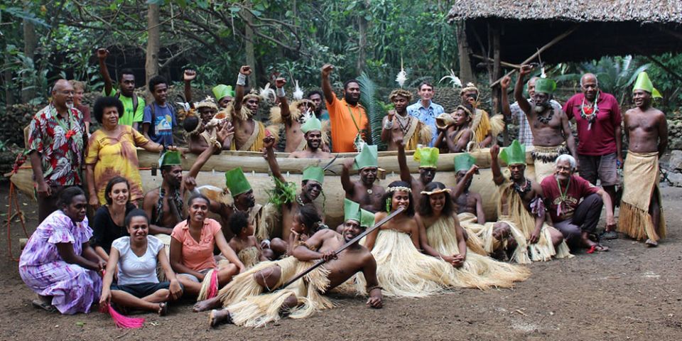 Members of the Pacific Climate Warriors on the island of Vanuatu pose with a canoe. (Courtesy of Pacific Climate Warriors)