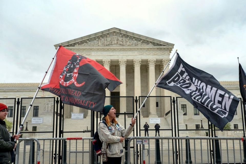 Protesters wave flags during a demonstration outside of the U.S. Supreme Court, Sunday, May 8, 2022, in Washington, D.C. A leaked draft opinion suggests the Supreme Court could be poised to overturn Roe v. Wade. 