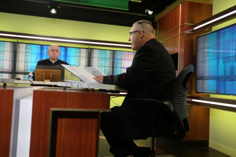 Archbishop José H. Gomez of Los Angeles, president of the U.S. Conference of Catholic Bishops, looks on as Msgr. Jeffrey D. Burrill, USCCB general secretary, reads a message to Pope Francis June 16, 2021. 