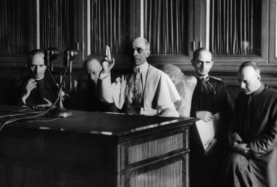 Pope Pius XII gives a blessing at the end of a radio message Sept. 1, 1943. (CNS)