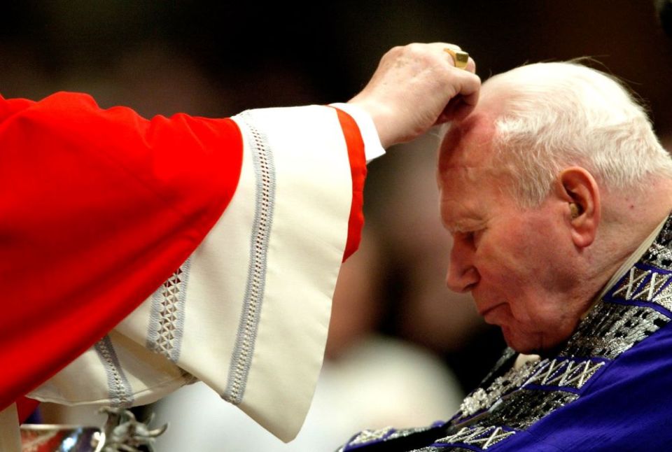 Pope John Paul II receives ashes from Cardinal Angelo Sodano during the Ash Wednesday liturgy at St. Peter's Basilica Feb. 25, 2004. Sodano, who died May 27 at age 94, served as John Paul II's secretary of state 1991-2006. (CNS/Reuters)
