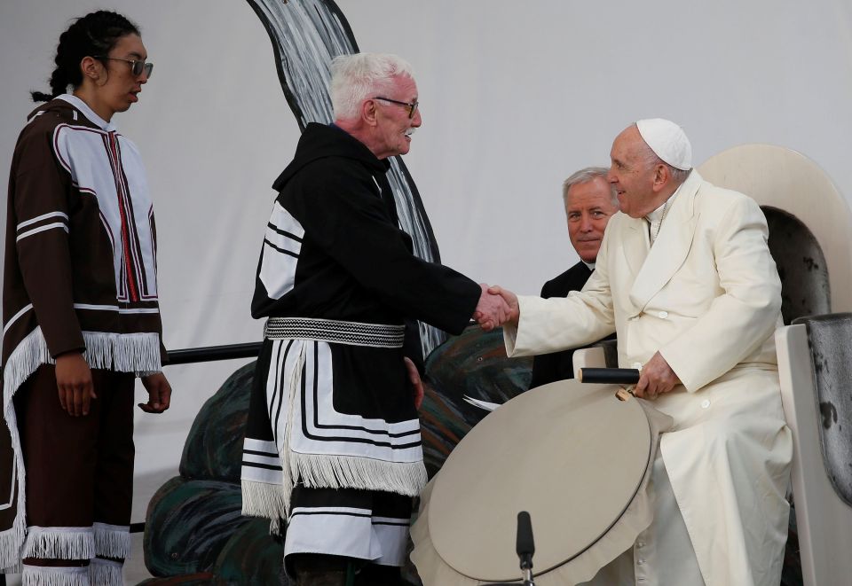Elder Piita Irniq and youth drum dancer Malachai Angulalik Mala present Pope Francis with a traditional drum during a meeting with young people and elders outside the primary school in Iqaluit in the Canadian territory of Iqaluit, Nunavut, July 29.