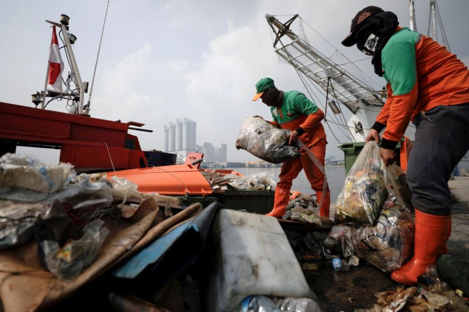 Municipal workers unload bags of garbage collected from the shore during World Oceans Day at Kali Adem Port in Jakarta, Indonesia, June 8, 2021.