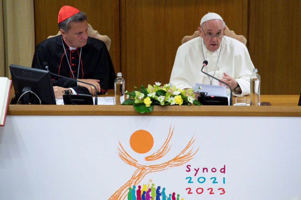 Pope Francis speaks as Maltese Cardinal Mario Grech, secretary-general of the Synod of Bishops, looks on during a meeting with representatives of bishops' conferences from around the world at the Vatican in this Oct. 9, 2021, file photo. 