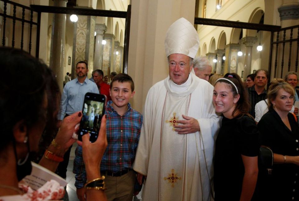 New Cardinal Robert W. McElroy of San Diego takes a photo with people after celebrating a Mass of thanksgiving at St. Patrick's Church, official home of the U.S. Catholic community in Rome, Aug. 28. (CNS/Paul Haring)