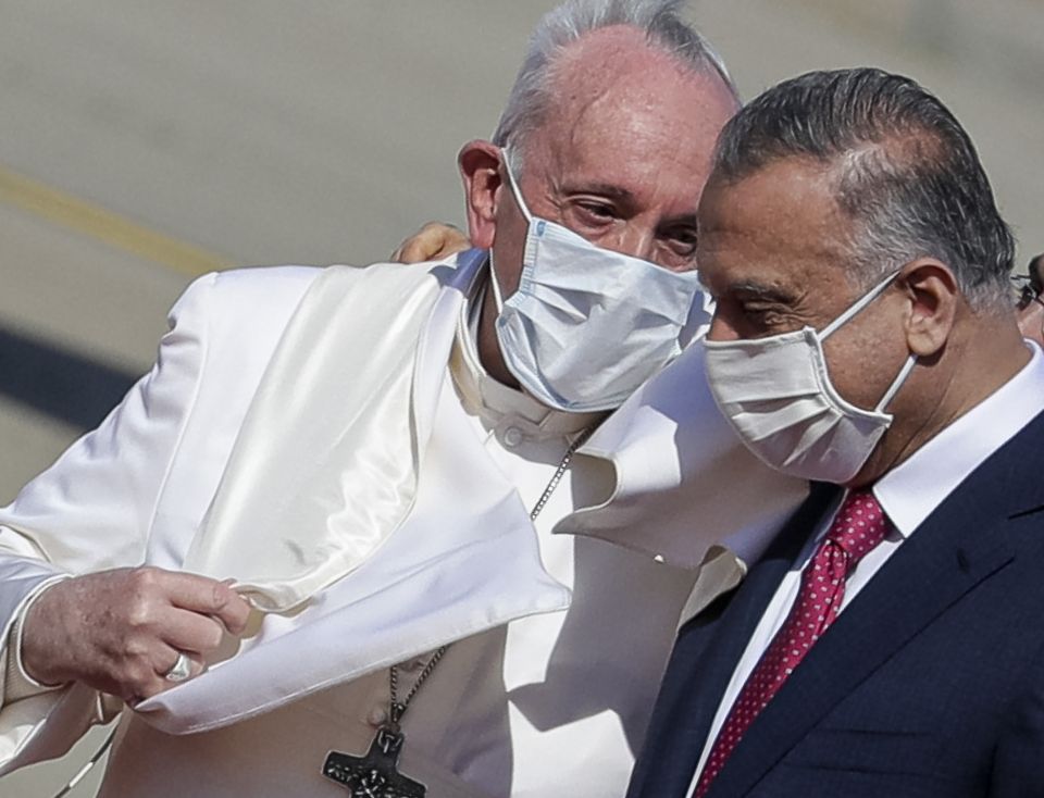 Pope Francis is greeted by Iraqi Prime Minister Mustafa al-Kadhimi as he arrives at Baghdad's international airport, Iraq, on March 5, 2021. (AP Photo/Andrew Medichini) Pope Francis is greeted by Iraqi Prime Minister Mustafa al-Kadhimi as he arrives at Baghdad's international airport, Iraq, on March 5, 2021. (AP Photo/Andrew Medichini)