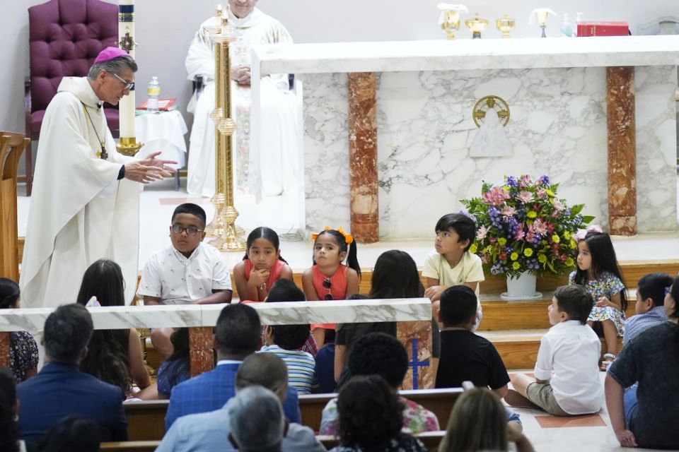 San Antonio Archbishop Gustavo García-Siller talks with children as President Joe Biden and First Lady Jill Biden attend Mass at Sacred Heart Catholic Church, after a school shooting May 29 in Uvalde, Texas. (AP/Evan Vucci)