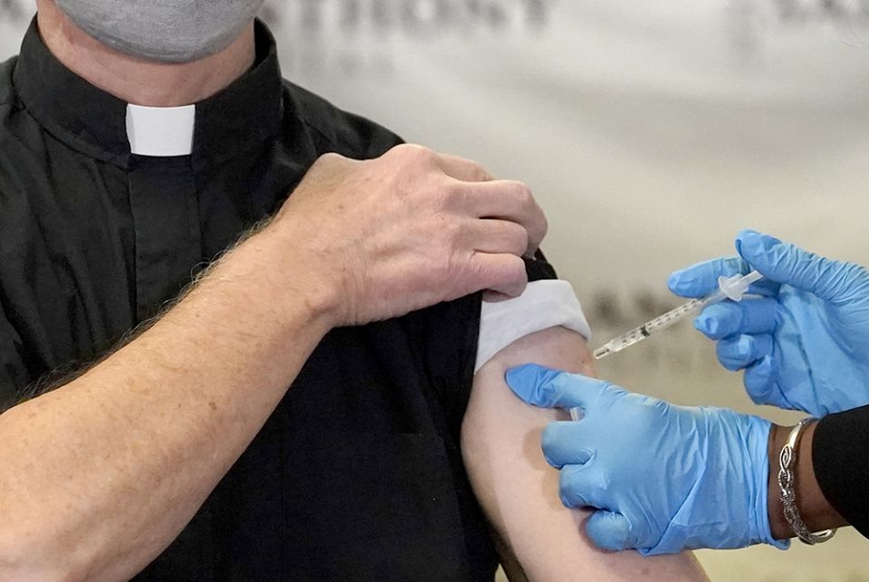 In this Dec. 23, 2020, file photo, a Catholic pastor receives the first of the two Pfizer-BioNTech COVID-19 vaccinations at a hospital in Chicago. In this Dec. 23, 2020, file photo, a Catholic pastor receives the first of the two Pfizer-BioNTech COVID-19 vaccinations at a hospital in Chicago. (AP)