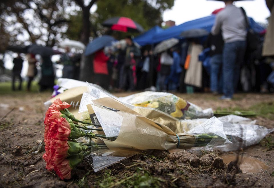 Flowers are left at the burial site of 1,457 unclaimed dead individuals in Los Angeles County from 2016 during an interfaith ceremony at the Los Angeles County Crematory and Cemetery, Dec. 4, 2019, in Los Angeles. (AP)