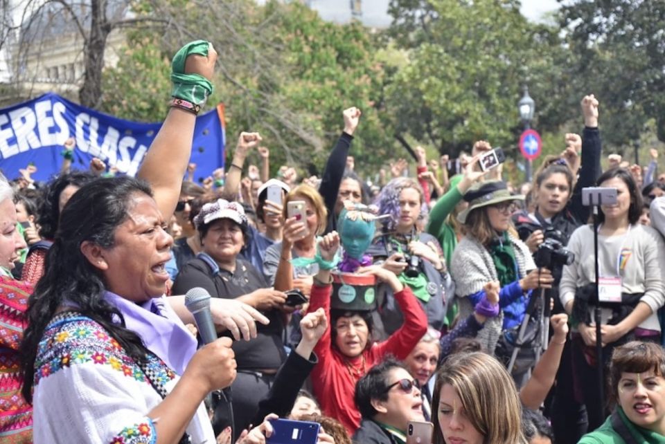 Aura Lolita Chávez Ixcaquic, left, speaks at a rally. (Courtesy Council of K'iche Peoples)