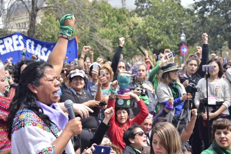 Aura Lolita Chávez Ixcaquic, left, speaks at a rally. (Courtesy Council of K'iche Peoples)