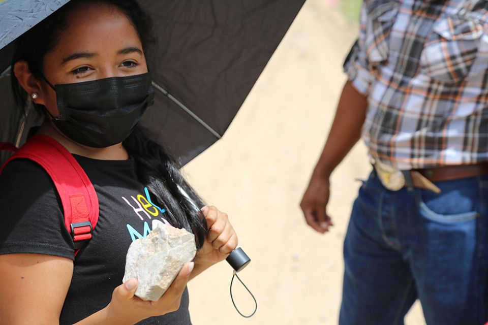 Yorito resident Aura Murillo Torres, 35, holds up a rock as she recalls how two years earlier town residents banded together, armed with stones like the one she holds, to fight off a mining company and its contingent of armed security.