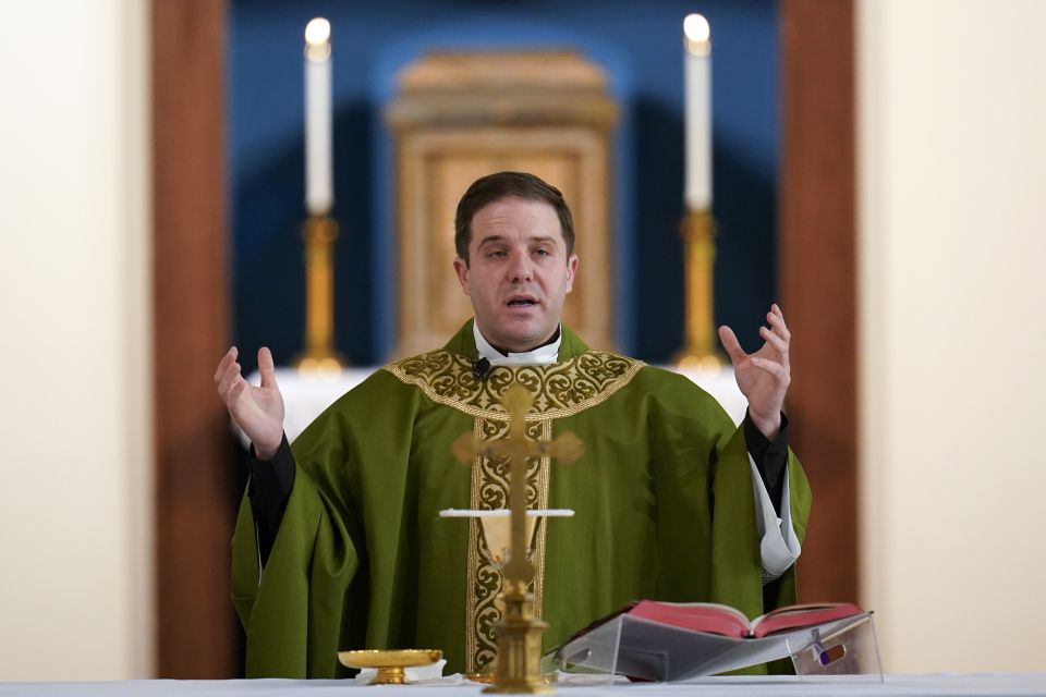 Father Matthew Hood celebrates mass at Our Lady of the Rosary church Friday, Feb. 18, 2022, in Detroit. (AP Photo/Paul Sancya) Father Matthew Hood celebrates mass at Our Lady of the Rosary church Friday, Feb. 18, 2022, in Detroit. (AP Photo/Paul Sancya)