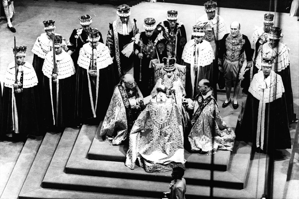 On June 2, 1953, Britain's Queen Elizabeth II, seated on the throne, receives the fealty of the Church of England's archbishop of Canterbury, center with back to camera, the bishop of Durham, left and the bishop of Bath and Wells, during her coronation.