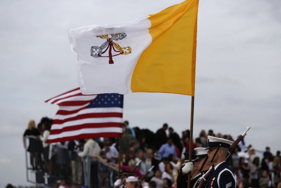 Vatican and U.S. flags are held by a military color guard during ceremonies welcoming Pope Francis upon his arrival at Joint Base Andrews outside Washington Sept. 22, 2015. (CNS/Reuters/Jonathan Ernst)