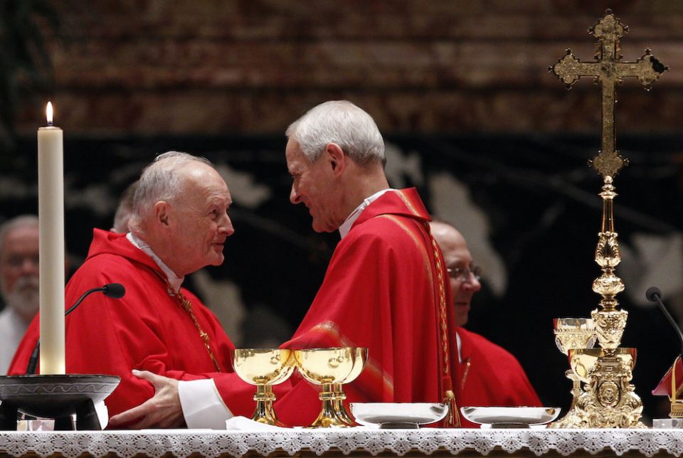 Cardinal Donald Wuerl of Washington, D.C., right, greets then-Cardinal Theodore McCarrick, retired archbishop of Washington, during the sign of peace at a Mass of thanksgiving in St. Peter's Basilica at the Vatican Nov. 22, 2010. (CNS/Paul Haring) 