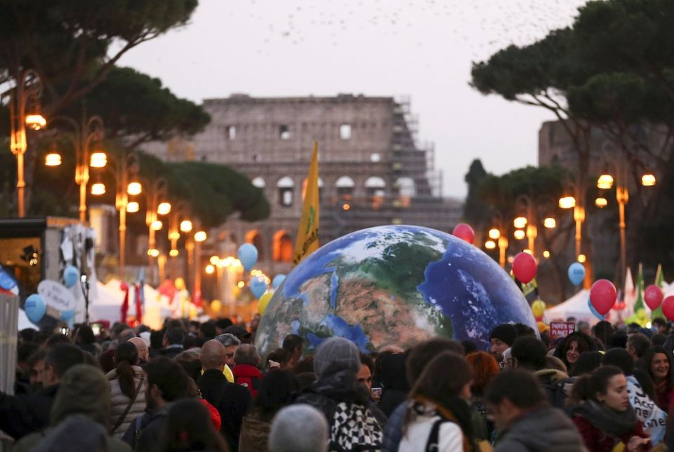 Protesters carry a globe-shaped balloon in front of Rome's Colosseum during a Nov. 29, 2015, rally, the day before the start of the U.N. climate change conference in Paris. (CNS/Reuters/Alessandro Bianchi)