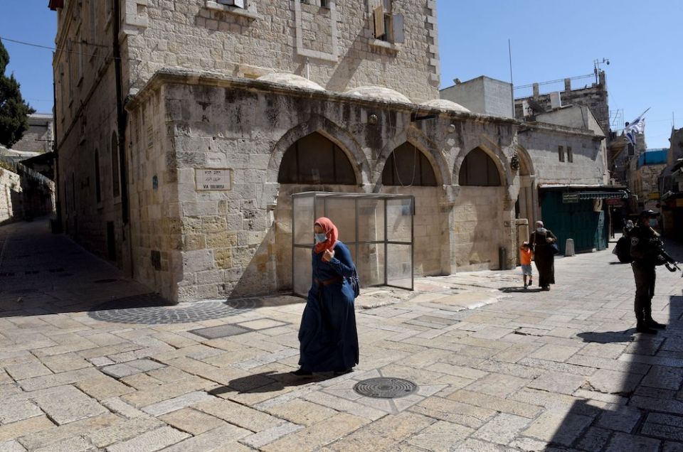 A Palestinian walks on the empty Via Dolorosa in the Old City of Jerusalem during a COVID-19 lockdown Oct. 6. (CNS/Debbie Hill)