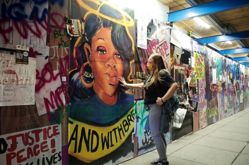A woman touches a Breonna Taylor mural at Black Lives Matter Plaza in Washington, D.C., Sept. 24. (CNS/Reuters/Cheriss May)