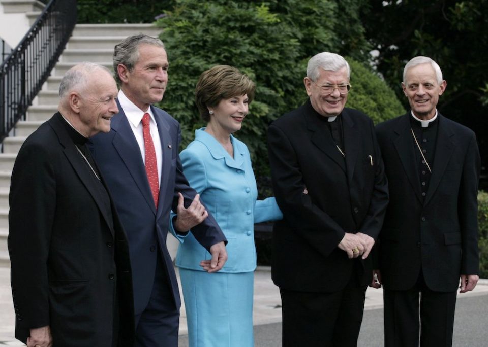 Posing for photographers on the South Lawn of the White House in Washington July 18, 2006, are former-Cardinal Theodore McCarrick, then-retired archbishop of Washington; U.S. President George W. Bush; first lady Laura Bush; Archbishop Pietro Sambi, aposto
