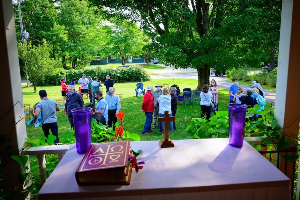 People spend time in conversation following an outdoor Mass celebrated at the home of Larry and Diane Kahlscheuer on Washington Island, Wisconsin, Sept. 6, 2020, during the pandemic. (CNS/The Compass/Sam Lucero) People talking in a yard